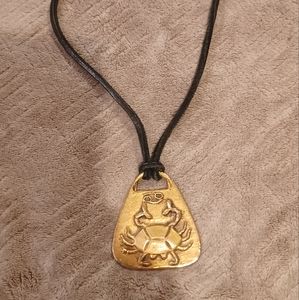 Necklace with large brass pendant with a crab in relief leather strap
